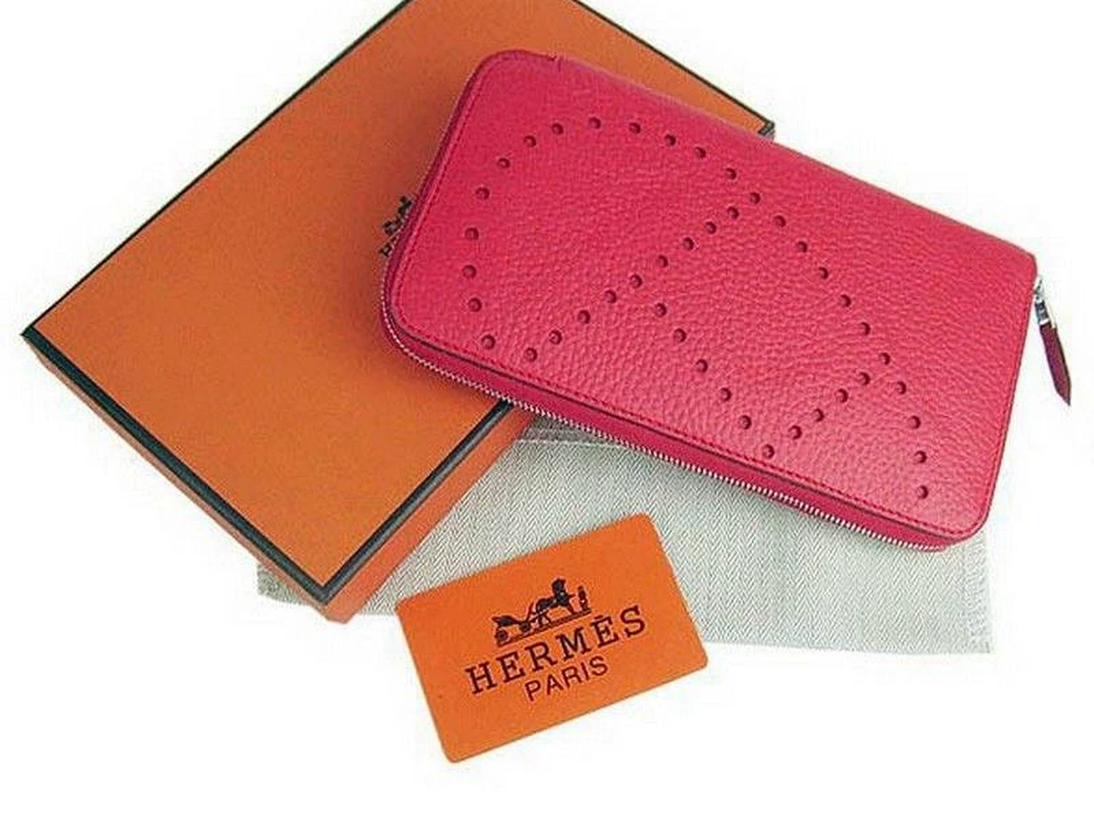 Portefeuille Hermès en cuir grainé fuchsia avec coffret orange